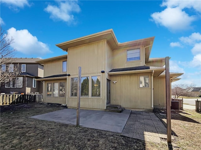 back of house featuring entry steps, a patio, central AC unit, and fence