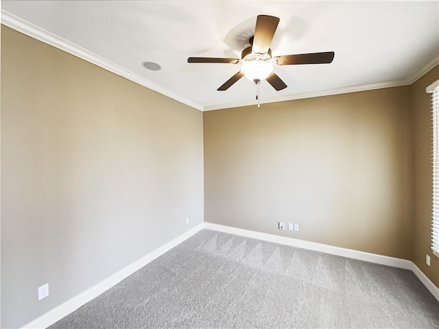 carpeted empty room featuring baseboards, a ceiling fan, and crown molding