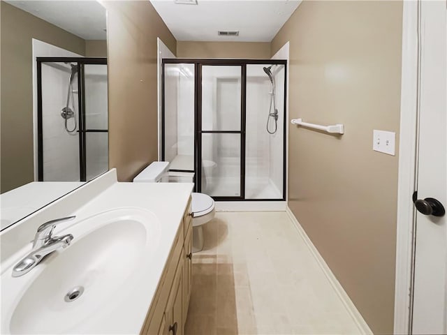 full bath featuring vanity, a shower stall, toilet, and visible vents