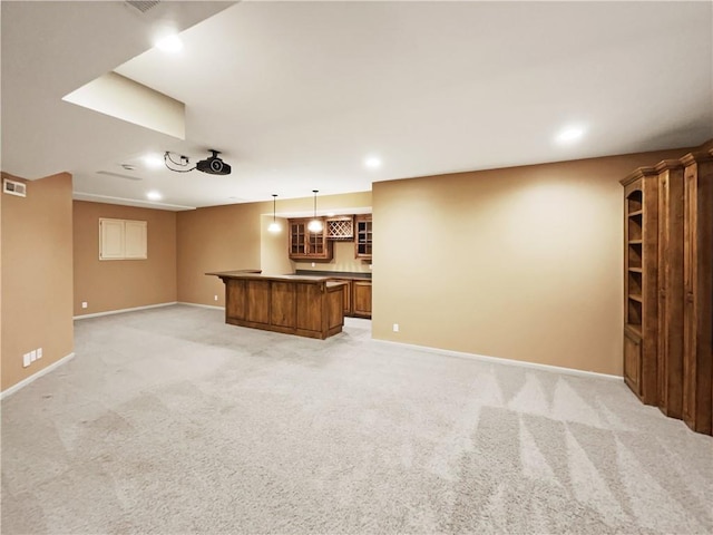 unfurnished living room with light carpet, recessed lighting, indoor bar, and baseboards