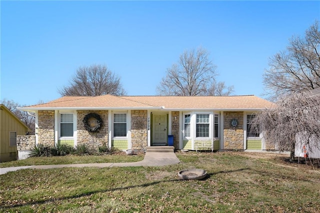 single story home with stone siding and a front yard