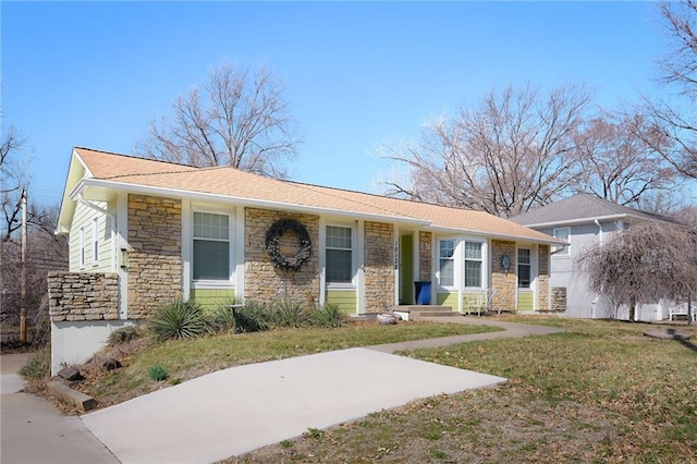 view of front of house featuring stone siding and a front yard