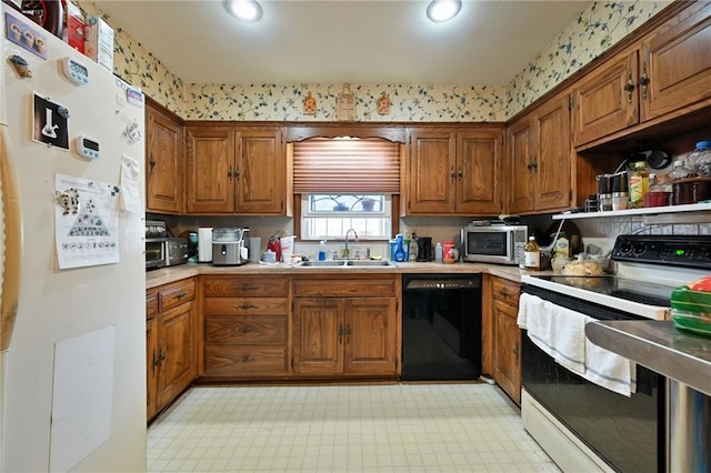 kitchen featuring white appliances, light countertops, brown cabinets, and a sink