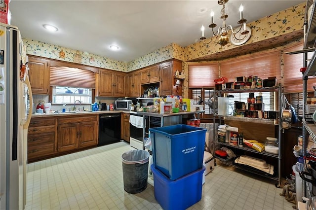 kitchen featuring a sink, stainless steel microwave, black dishwasher, white fridge with ice dispenser, and an inviting chandelier