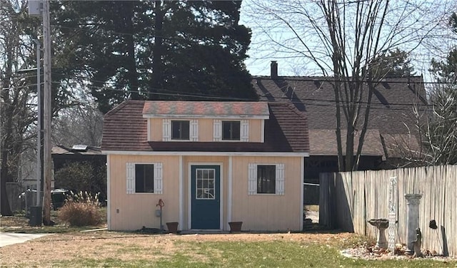 view of outbuilding featuring an outbuilding and fence