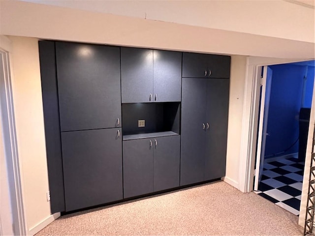 unfurnished bedroom featuring a closet, baseboards, and light floors