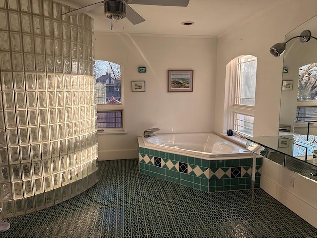 full bath featuring tile patterned flooring, a garden tub, crown molding, and ceiling fan