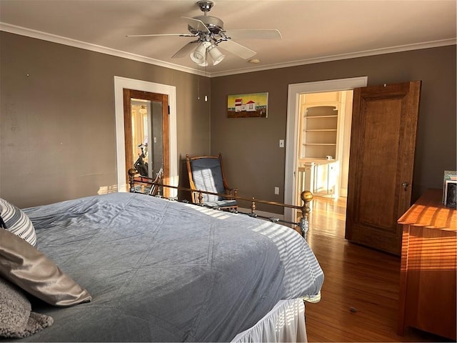 bedroom featuring crown molding, wood finished floors, and ceiling fan