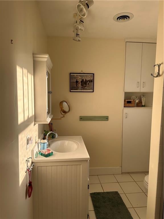 bathroom with vanity, visible vents, and tile patterned flooring