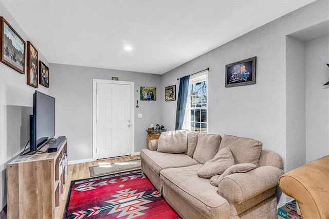 living room featuring baseboards and light wood-type flooring