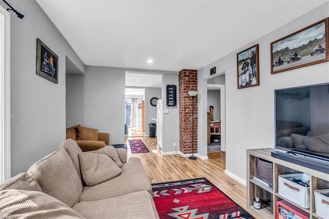 living room featuring wood finished floors and baseboards