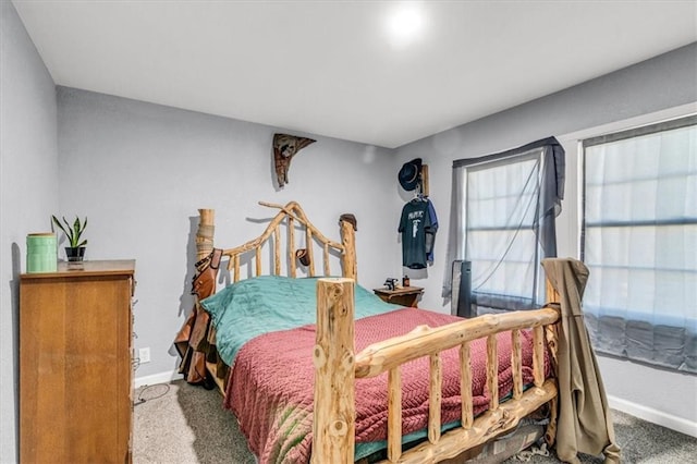 carpeted bedroom featuring baseboards