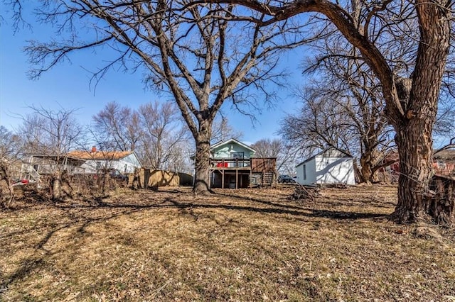 view of yard featuring a deck and stairs