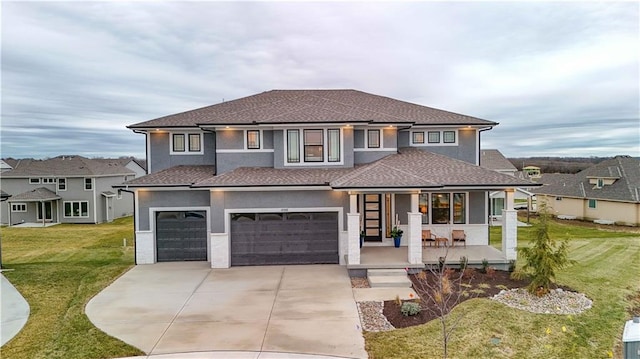 view of front of house featuring a front lawn, covered porch, stucco siding, a garage, and driveway