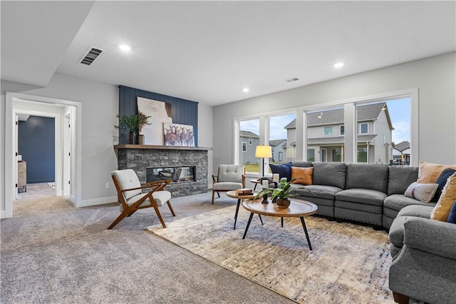 living area with visible vents, baseboards, carpet, recessed lighting, and a fireplace