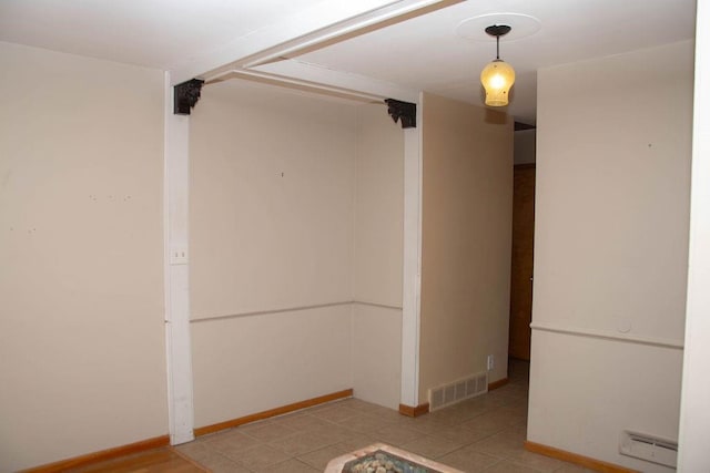 unfurnished room featuring visible vents and baseboards