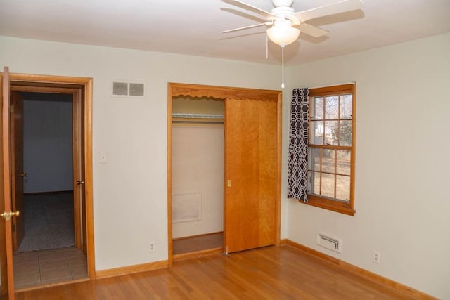 unfurnished bedroom featuring baseboards, visible vents, and light wood-type flooring