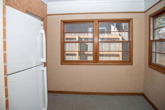 unfurnished dining area featuring baseboards