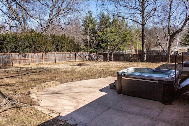 view of patio / terrace featuring a hot tub and a fenced backyard