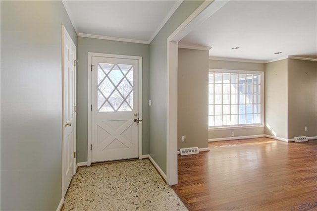 entrance foyer featuring visible vents, baseboards, and crown molding