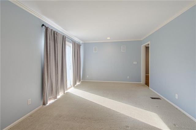 empty room featuring visible vents, ornamental molding, baseboards, and carpet floors