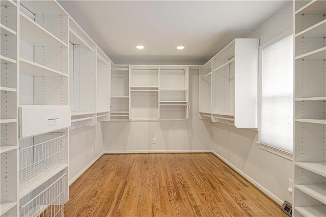 walk in closet featuring visible vents and wood finished floors