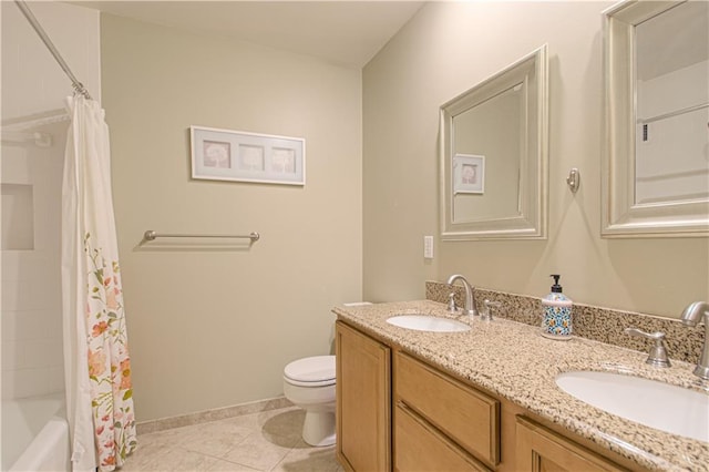 full bathroom with tile patterned flooring, double vanity, toilet, and a sink