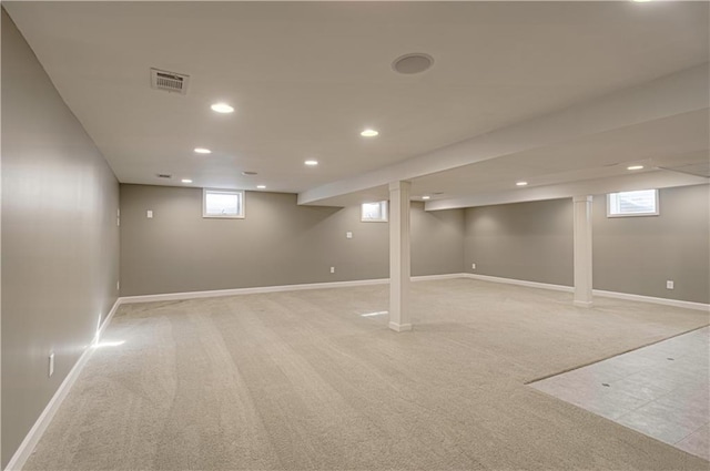 basement with visible vents, recessed lighting, light colored carpet, and baseboards