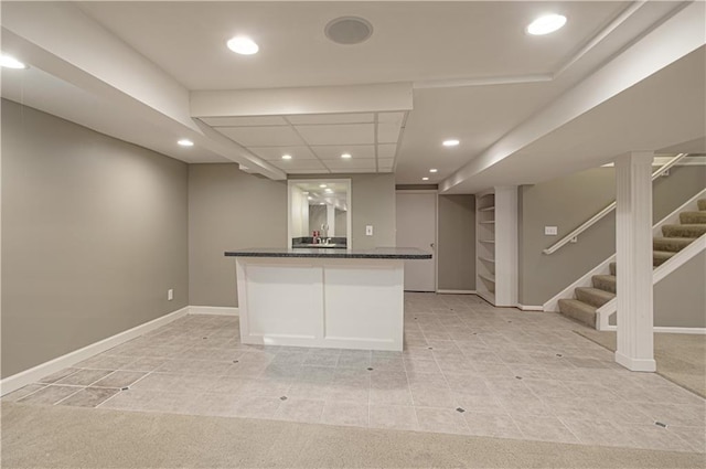 kitchen with dark stone counters, recessed lighting, and baseboards