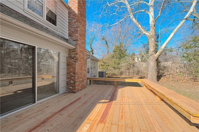 wooden deck featuring cooling unit