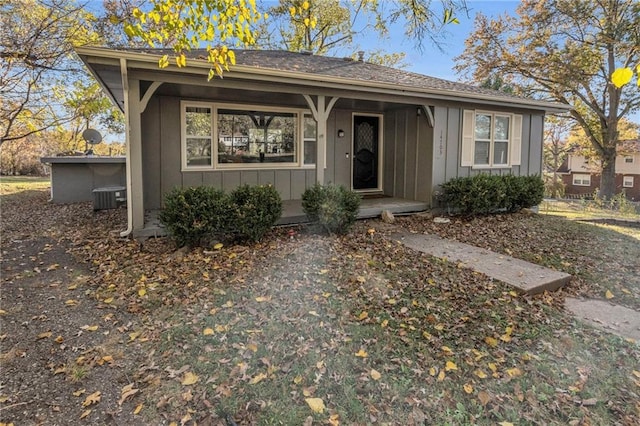 view of front of house featuring covered porch, board and batten siding, and central AC