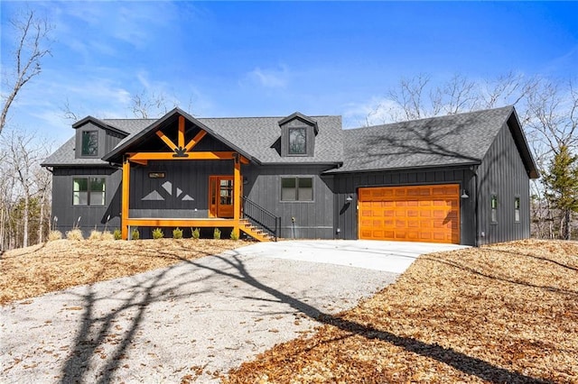 modern farmhouse with a garage, roof with shingles, and driveway