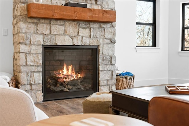 interior details with wood finished floors and a fireplace