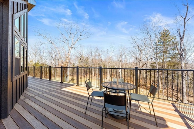 wooden terrace featuring outdoor dining area