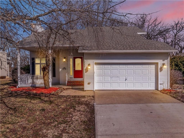 view of front of home featuring covered porch, concrete driveway, a garage, and a shingled roof