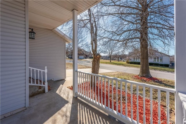 view of patio / terrace with a residential view and a porch