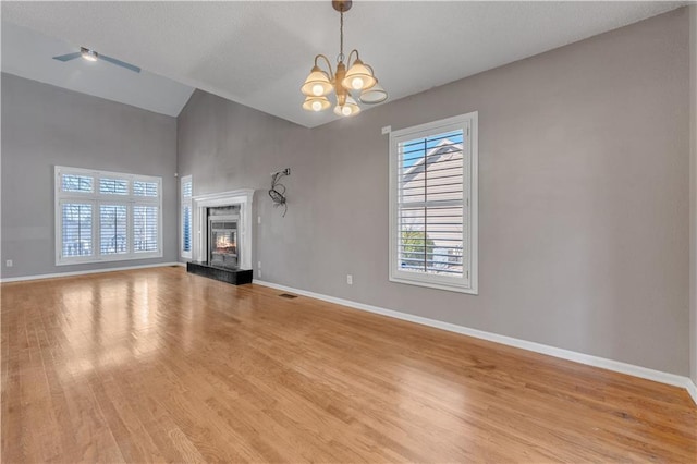 unfurnished living room with light wood-style flooring, a fireplace, and baseboards