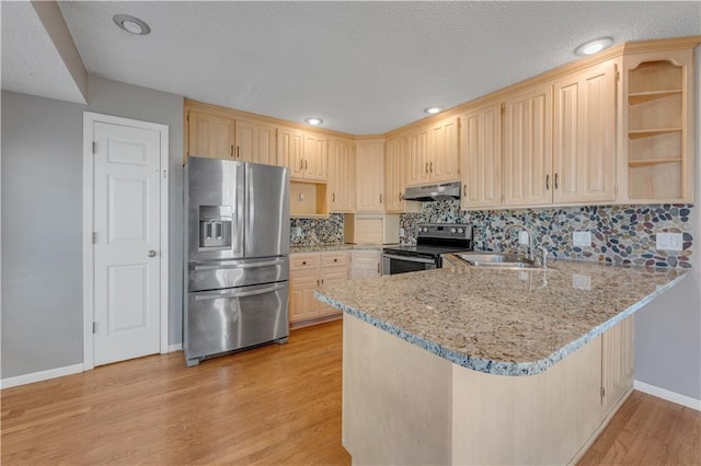 kitchen with light brown cabinets, under cabinet range hood, appliances with stainless steel finishes, a peninsula, and a sink