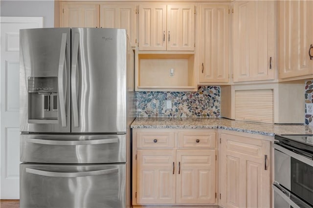 kitchen featuring light stone counters, decorative backsplash, and appliances with stainless steel finishes