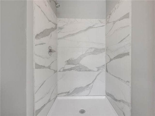 bathroom with a marble finish shower