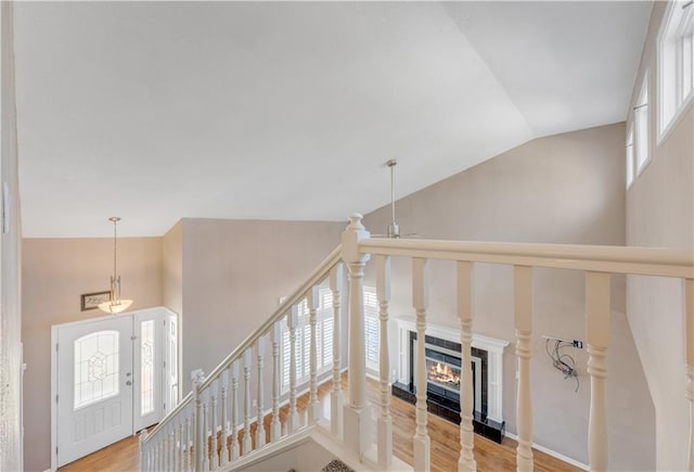 interior space with lofted ceiling, wood finished floors, a fireplace, and ceiling fan