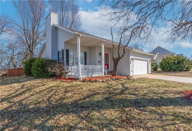 view of front of home featuring a front yard, driveway, a porch, an attached garage, and a chimney