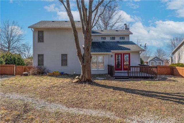 view of front of home featuring a wooden deck, a front yard, and fence