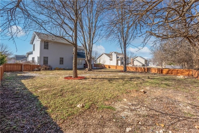 view of yard with a fenced backyard and a residential view