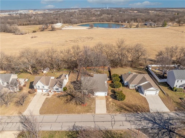 drone / aerial view with a water view and a residential view