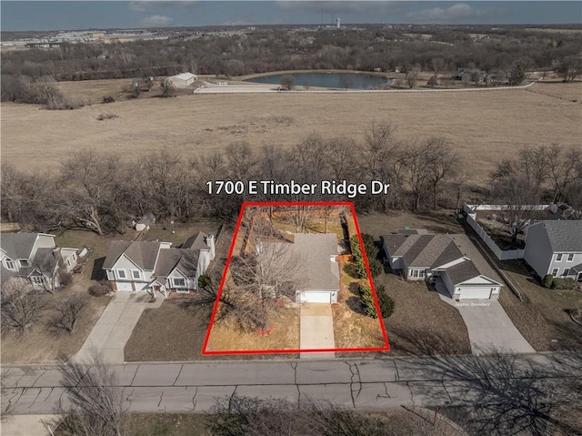 birds eye view of property with a residential view and a water view