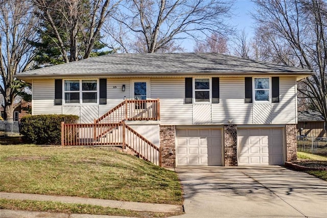 view of front of house featuring a front yard, a garage, brick siding, and driveway