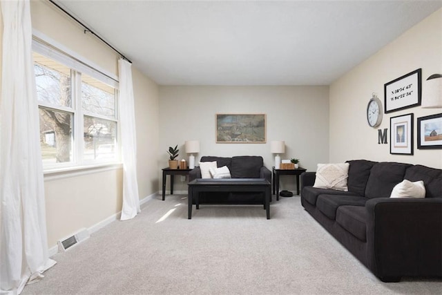 carpeted living room with visible vents and baseboards