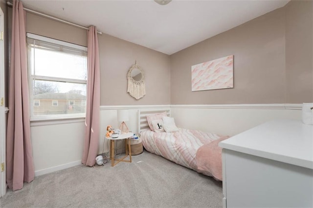 carpeted bedroom featuring baseboards