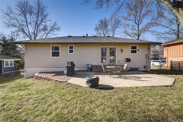 back of house featuring a patio area, a lawn, french doors, and fence